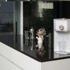 AOX Compac O2+ water dispenser elegantly placed in a modern kitchen with a glass and floral decor.