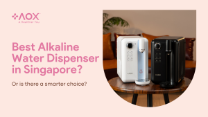 AOX white and black alkaline water dispensers on a wooden table in a modern Singapore home, showcasing a healthier alternative to traditional systems.