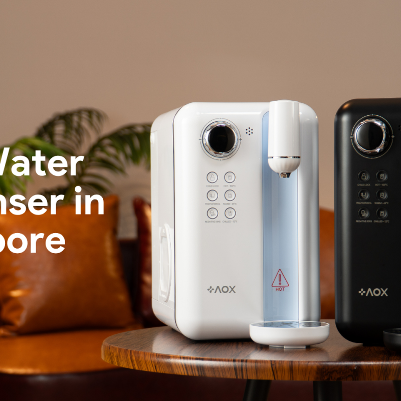 AOX white and black water dispensers on a wooden table in a stylish Singapore home, highlighting the best water dispenser choice for 2025.